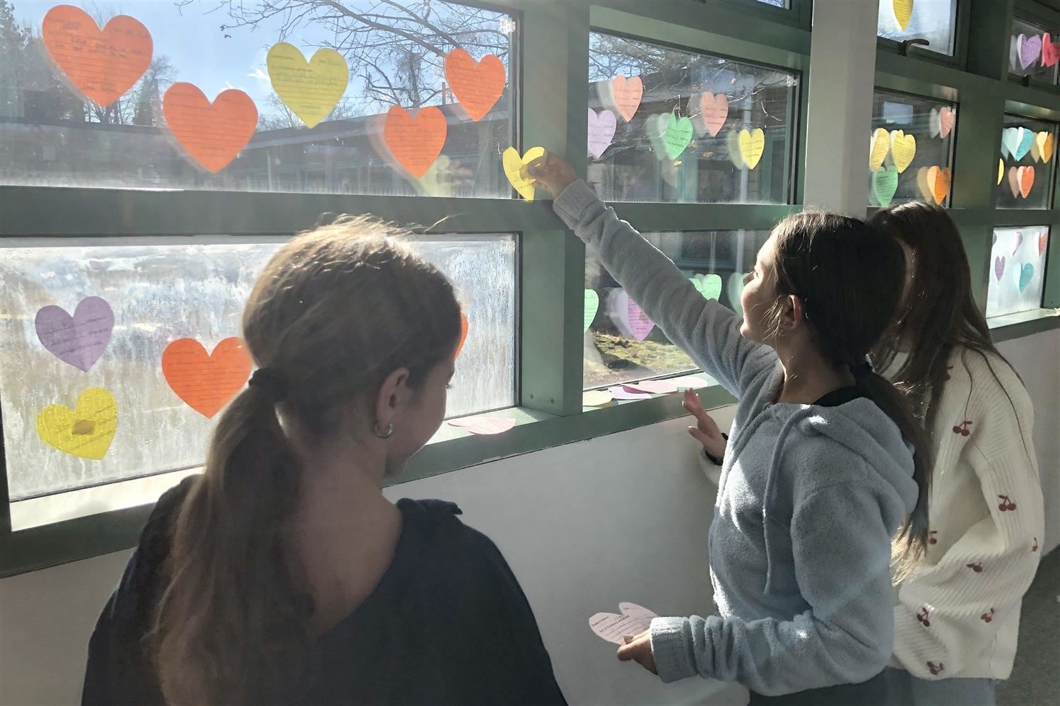 students placing hearts